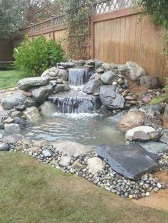 a small waterfall in the middle of a garden