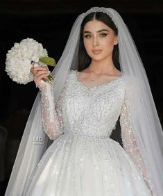 a woman in a wedding dress holding a bouquet