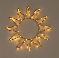 a light up sunburst is hanging on the wall