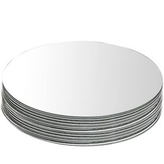 a stack of silver plates sitting next to each other on top of a white surface