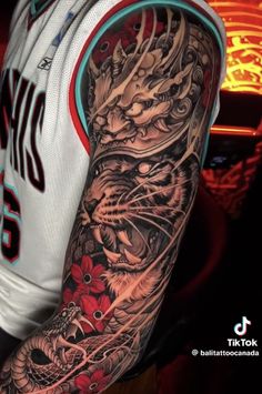 a man with a dragon tattoo on his arm