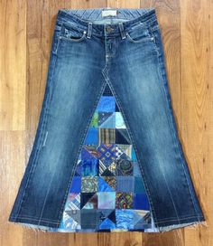 a skirt made out of jeans with different colored patches on the bottom, and one side