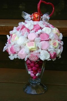 a glass vase filled with candy and candies