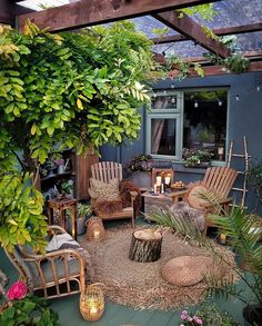 an outdoor living area with chairs, tables and potted plants