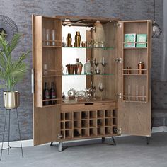 a wooden cabinet filled with lots of bottles and glasses