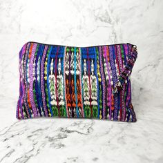 A true work of art, each Corte Cosmetic Bag is lovingly crafted on a traditional pedal loom with the same vibrant fabrics that fashion the iconic skirts of Guatemalan women. This results in an exclusive and one-of-a-kind product that will add a touch of luxury and culture to your collection. Each one has enough space to hold all of your needs, from makeup to brushes to nail polish and more! As always, Handmade and Fair Trade! 9" H x 6" W Brightly lined with nylon Zipper pull-tab 100% cotton Asso Artisan Multicolor Woven Shoulder Bag, Multicolor Woven Shoulder Bag As Gift, Multicolor Handwoven Pouch Bag, Colorful Bohemian Woven Bag, Artisan Multicolor Handwoven Bag, Multicolor Artisan Handwoven Bag, Multicolor Handwoven Artisan Bag, Traditional Multicolor Woven Bags, Multicolor Travel Bags With Weaving Work