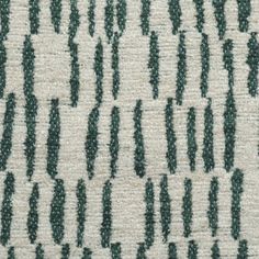 an upholstered fabric with green and white designs