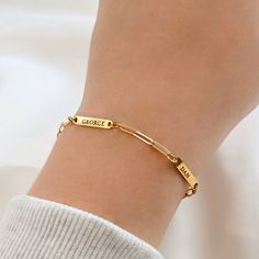 Our Engraved Name Bracelet lets you wear your loved ones close. Choose one or more name bars, each engraved on one side only. Pick your chain style: curb or paperclip, available in 6", 7" and 8" lengths, plus a 2" extender. Made from stainless steel with 18k gold PVD plating or a silver finish, this bracelet is waterproof and tarnish-free. Material: Stainless Steel  Finish: Silver and 18k Gold PVD Plated Chain Type: Dainty Paperclip & 3mm Curb Chain Length: 6", 7" and 8" + 2" extender Number of Classic Gold Bracelets For Friendship, Personalized Yellow Gold Metal Bracelets, Personalized Yellow Gold Metal Bracelet, Gold Name Charm Bracelet For Friendship, Personalized Link Bracelets For Everyday, Classic Gold Name Bracelet For Friendship, Gold Name Bracelets For Friendship, Gold Rectangular Name Bracelets, Rectangular Gold Name Bracelets