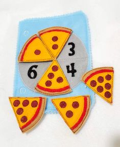 a piece of felt with numbers and slices of pizza on it