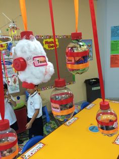 there is a child standing in front of a table with candy and water bottles on it