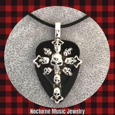 For the love of Goth! 💀 For women and men  Large silver Cross of Skulls Charm on black celluloid and black delrin picks.  Large silver bail.  Solid and sturdy pendant.  Length approx 2 inches.  Style choice:  Stainless Steel Chain 24" Stainless Steel Chain 20" Black leather cord 18" (w/2" ext) Gothic Cross, Gothic Crosses, Star Charm Necklace, Music Jewelry, Skull Pendant, Metal Charm, Silver Cross, Star Charms, Steel Chain