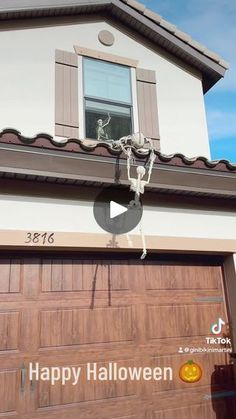 an image of a house with a happy halloween message on the front door and window