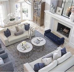 an aerial view of a living room with couches, chairs and fireplace in it