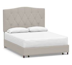 a bed with white linens and pillows on top of it, against a white background