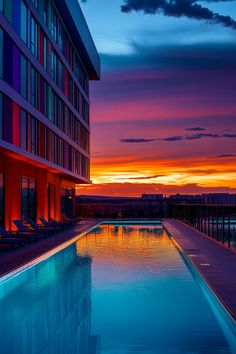 A hotel infinity pool offering a breathtaking view of a mountain range with sunset hues lighting up the sky. Pool With A View, City Skylines, Stunning Landscapes