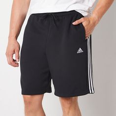 Throw this pair of adidas men's workout shorts into the mix for on-trend active days. Crafted from soft cotton-fleece, these mid-length shorts have an elastic-waist, side slip pockets, and a design featuring the brand's signature stripes and logo. Team them with a tank top or t-shirt and sneakers. Front Style: Flat FrontClosure Type: Full ElasticFit: Regular FitPockets: 2 Side Slip PocketsRise: At WaistShort Length: Mid LengthFiber Content: 78% Cotton, 22% PolyesterFabric Description: FleeceInse Cotton Activewear With Three Stripes For Sports Season, Cotton Activewear With Three Stripes In Relaxed Fit, Adidas Cotton Activewear, Adidas Cotton Sporty Activewear, Adidas Cotton Shorts With Three Stripes Branding, Adidas Cotton Gym Bottoms, Cotton Activewear With Three Stripes For Workout, Three Stripes Relaxed Fit Activewear For Workout, Relaxed Fit Activewear For Workout