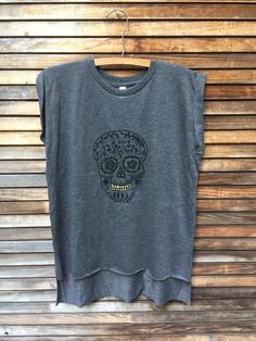 "Throw this top on for an easy look to the gym, out in the yard or headed to the beach. i print my sugar skull in black with gold hand painted teeth for a little pop. this tee is super soft and easy to wear in a soft poly/viscose mix so it feels silky smooth on the skin. the sleeves are rolled and tacked in place and the back runs much longer than the front. crewneck with a loose fitting, boxy style. these run big but i still wear my normal medium so that it's nice and comfy- loose + easy for th Casual Gym T-shirt With Screen Print, Relaxed Fit Gray Top For Beach, Sleeveless Letter Print T-shirt For Beach, Moisture-wicking Crew Neck T-shirt For Beach, Cotton Athleisure Tank Top For Beach, Summer Workout Muscle Tee With Short Sleeves, Summer Muscle Tee With Moisture-wicking And Relaxed Fit, Summer Moisture-wicking Muscle Tee With Relaxed Fit, Summer Moisture-wicking Relaxed Fit Muscle Tee