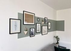 a living room with pictures on the wall