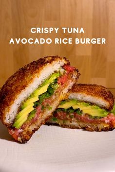 a sandwich cut in half sitting on top of a white plate with the words crispy tuna avocado rice burger