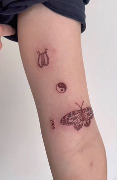 a small butterfly tattoo on the left arm