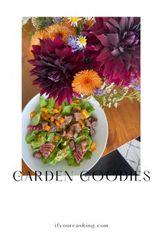 a white plate topped with salad next to purple and orange flowers