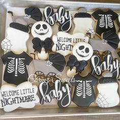 decorated cookies in the shape of skeleton and bow for baby's first birthday party