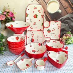 a table topped with lots of red and white dishes