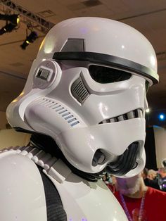 a star wars costume is displayed in front of a group of people at a convention