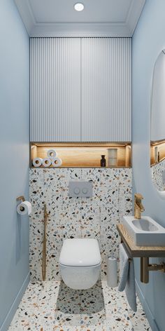 a white toilet sitting in a bathroom next to a sink