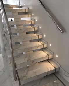 an image of a stair case with lights on the bottom and side steps to the second floor