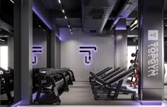 a gym with rows of black benches and purple lighting