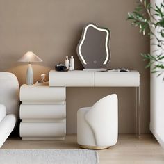 a white desk with a mirror on top of it next to a couch and lamp