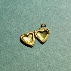 This small heart locket is approximately ~0.5 inches in size. The charm is made of raw brass and comes with a jump ring for threading on your favorite necklace or jewelry making. Brass Heart Charm Pendant Jewelry, Open Heart Charm Necklace Keepsake, Open Heart Charm Necklace For Keepsake, Brass Locket Necklace With Charms For Keepsake, Keepsake Open Heart Charm Necklace, Gold Brass Heart Charm Necklaces, Gold Brass Charm Necklace With Heart Charm, Heart-shaped Vintage Charm Jewelry For Keepsake, Heart-shaped Keepsake Charm Necklaces