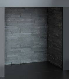 an empty room with a brick wall and floor