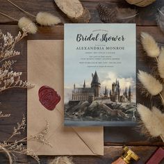 a wedding card with a castle on it next to some dried flowers and other items