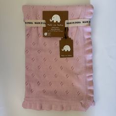 a pink blanket with an elephant on it and a tag hanging from the back of it