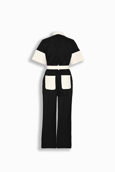 Our Arlo Jumpsuit, a belted jumpsuit with a band collar, open chest pockets, wide short sleeves, and straight-leg fit. Finished with a functional multi buttoned belt for adjustability and ivory back pockets. Cut from durable cotton fabric and secured with black buttons. Black and ivory coloring Midweight cotton fabric Band collar Front button closure Front and rear facing pockets Short dolman style sleeves 100% cotton Your order will ship from our warehouse in Florida, USA! Belted Cotton Jumpsuits And Rompers With Short Sleeves, Short Sleeve Jumpsuits And Rompers For Workwear, Workwear Jumpsuits With Short Sleeves And Belt Loops, Short Sleeve Belted Jumpsuits And Rompers For Work, Belted Short Sleeve Jumpsuits And Rompers For Work, Belted Short Sleeve Jumpsuits For Work, Fitted Cotton Belted Jumpsuits And Rompers, Belted Jumpsuit, Florida Usa