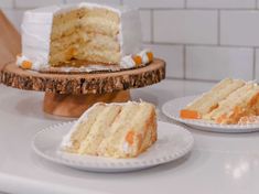 two slices of cake on plates sitting on a counter top next to another piece of cake