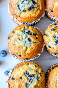 several blueberry muffins sitting on top of a table