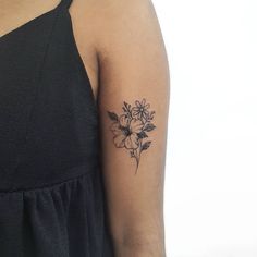 a woman with a flower tattoo on her arm