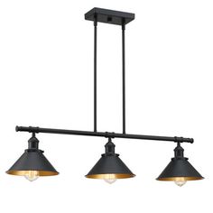 three lights hanging from the ceiling in an industrial style kitchen light fixture with black and gold shades