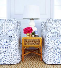 two chairs and a table with flowers on it