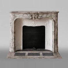 a white marble fireplace with black and grey tiles