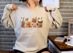 Fall Coffee Crewneck Sweatshirt, Fall Latte Pumpkin Spice Pullover Shirt, Cute Fall Sweater Design has been distressed for a vintage look. The sweatshirts in the pictures are solid color with soft fleece inner lining. They are not pigment-dyed or vintage. .: 50% Cotton 50% Polyester (Heather Colors are 40% Cotton 60% Polyester) .: Medium-heavy fabric (8.0 oz/yd² (271.25 g/m .: Loose fit .: Sewn in label .: Runs true to size PROPER SIZING Please see photos to see a specific sizing chart for this Relaxed Fit Coffee Color Tops For Fall, Casual Long Sleeve Coffee T-shirt, Coffee Long Sleeve Cotton Top, Distressed Long Sleeve T-shirt For Fall, Casual Coffee Long Sleeve Sweatshirt, Casual Long Sleeve Coffee Sweatshirt, Fall Coffee Cotton Sweatshirt, Fall Cotton Coffee Sweatshirt, Coffee Cotton Sweatshirt For Fall