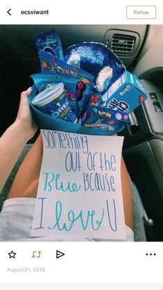 a person holding a sign in their car with the message i love you on it