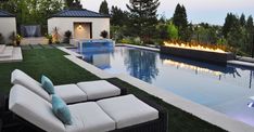 an outdoor pool with lounge chairs and fire pit