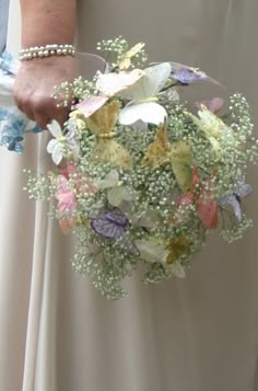 a bride holding a bouquet of flowers in her hand