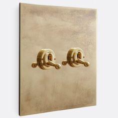 two golden handles on a light switch cover