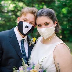 a bride and groom wearing masks to protect them from the sun