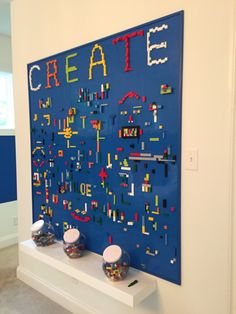 a blue wall with legos on it that says create